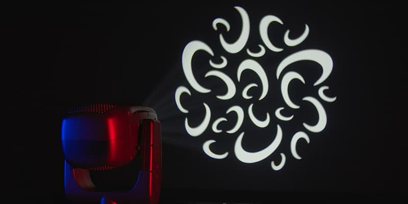 Claypaky Arolla Aqua projecting a rotating ornamental gobo, lit in red and blue