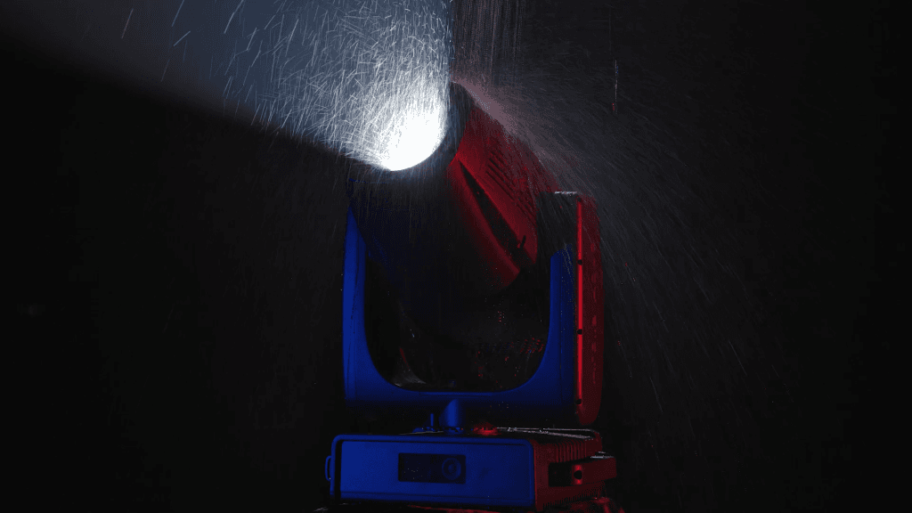 Claypaky Arolla Aqua cutting a beam through heavy rain — its IP66 weatherproof rating in action