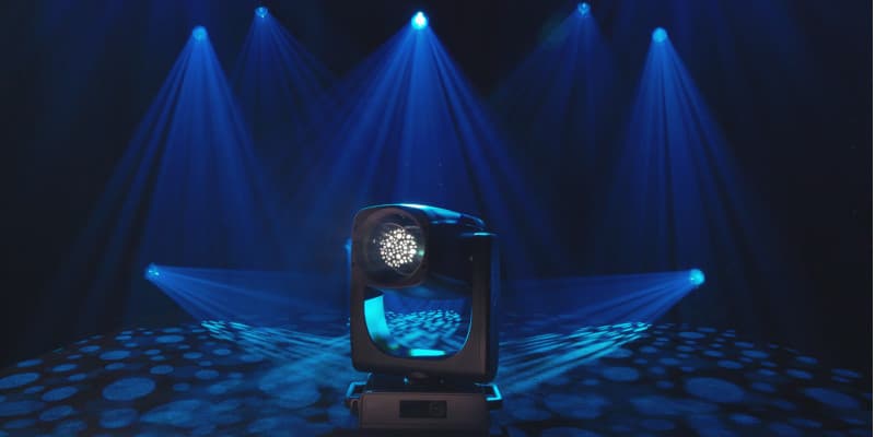 Claypaky Arolla Aqua M-LT on a stage, projecting blue beams and a dotted gobo across the floor